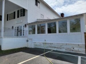 A white building with a fire hydrant in the middle of it.