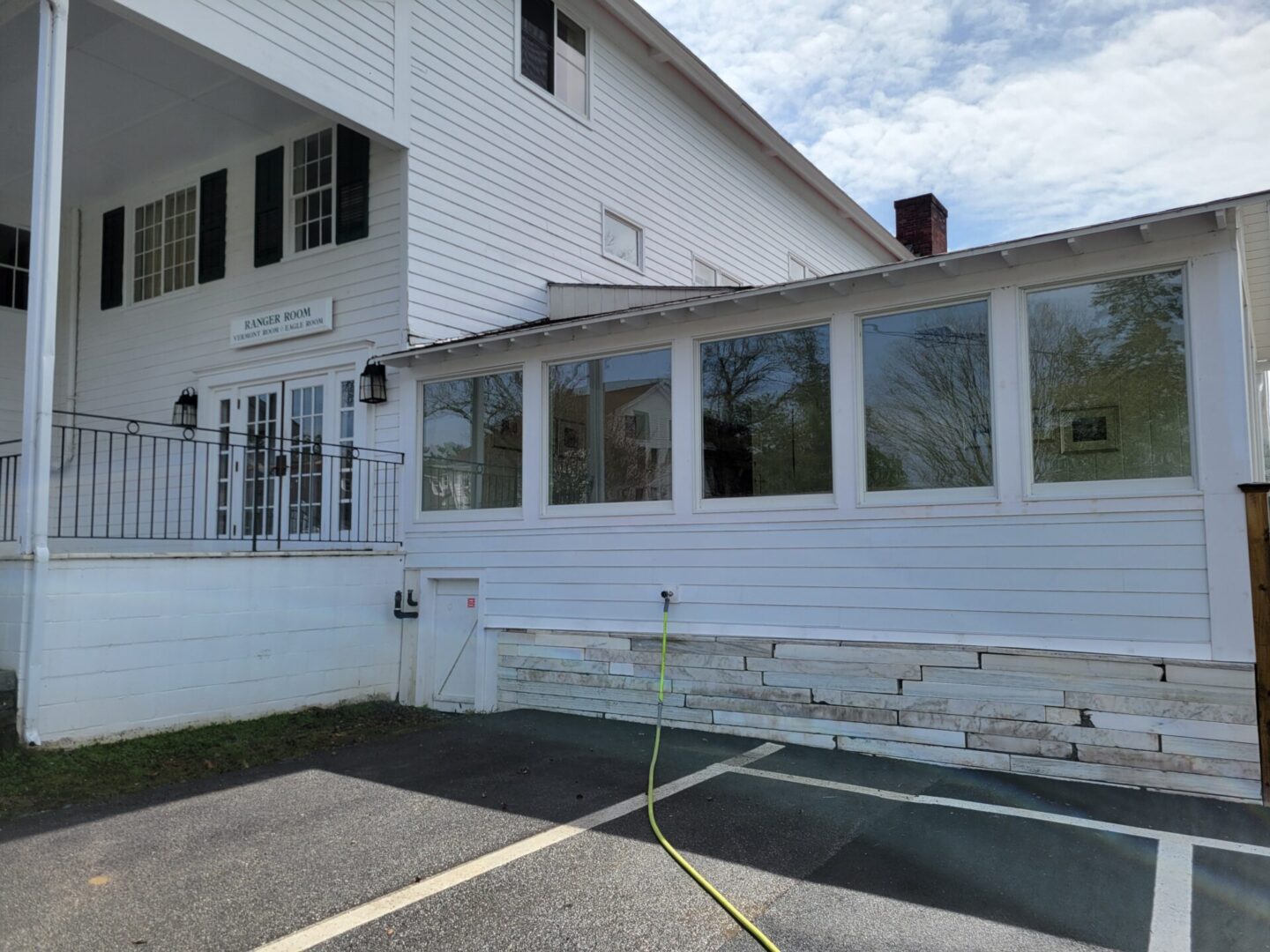 A white building with a fire hydrant in the middle of it.