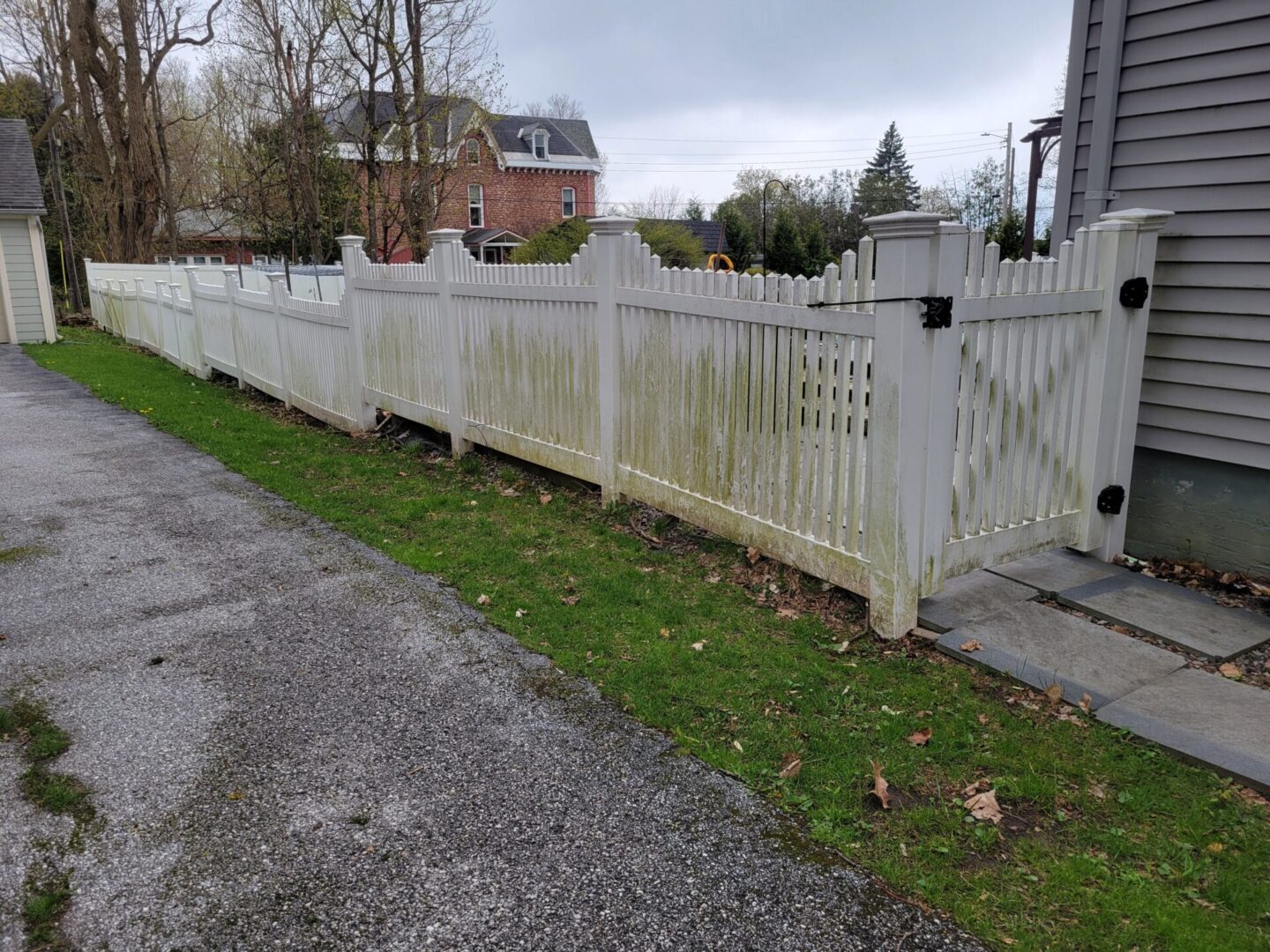A fence that has been cleaned and is in the grass.