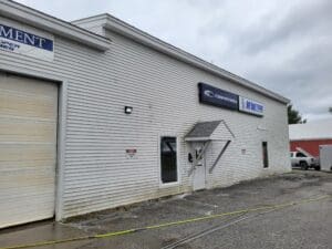 A white building with a large window on the side.