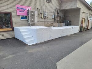 A large white sheet of plastic sitting outside.